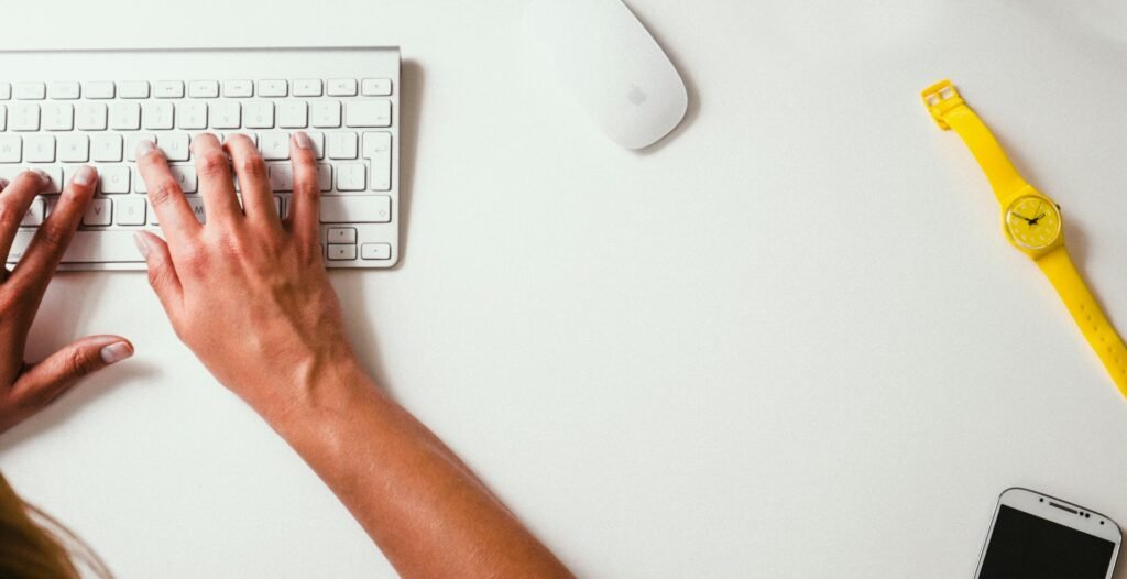 Hands typing code on a keyboard