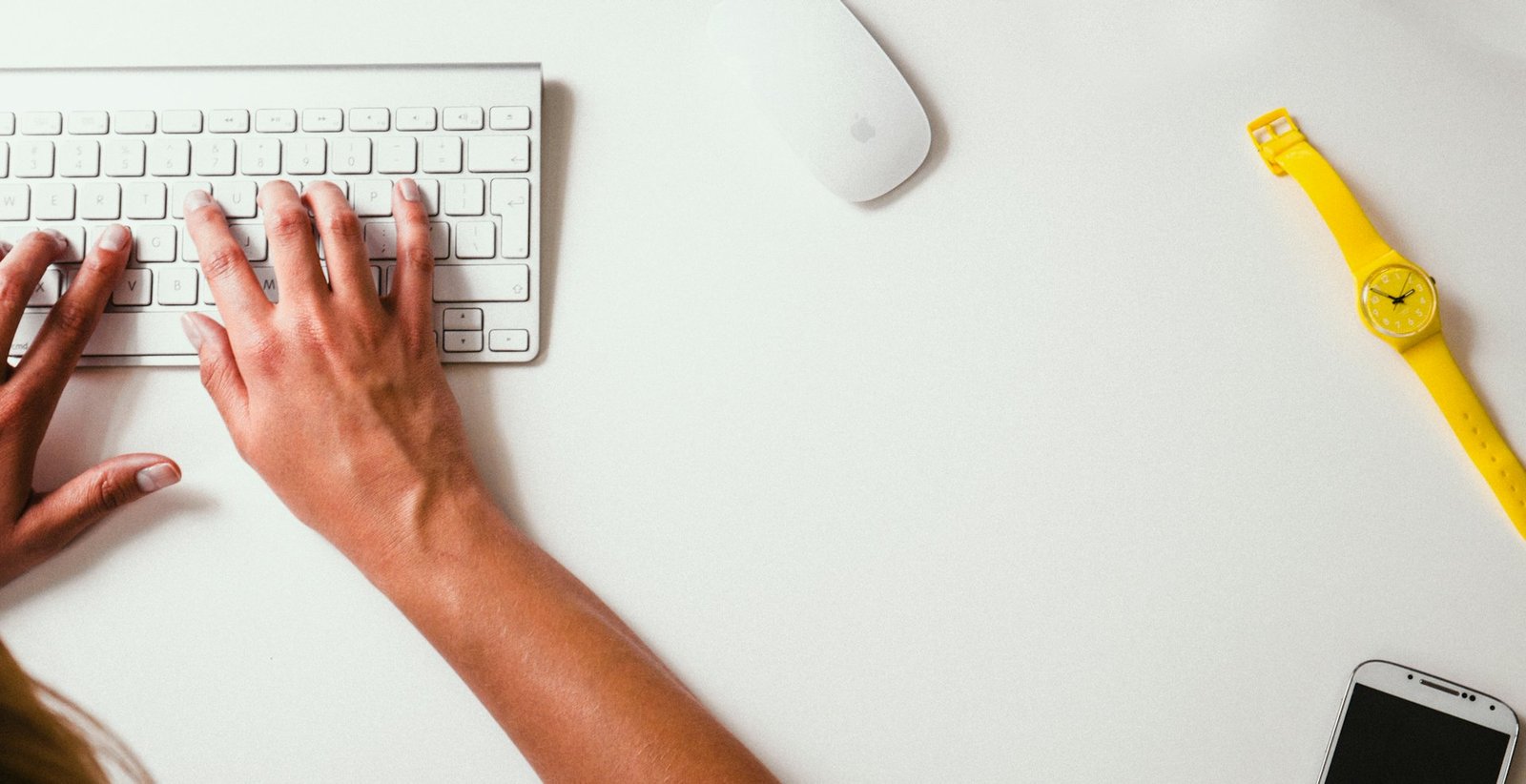 Hands typing code on a keyboard