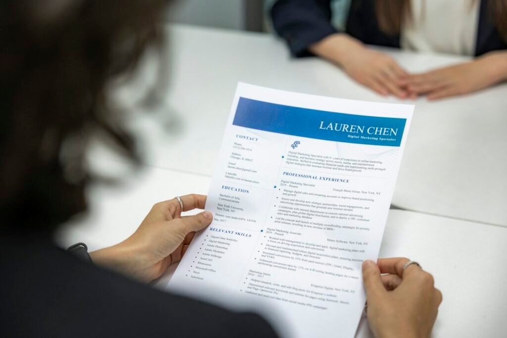 A reviewer reading a printed resume